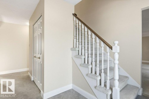 Stairway with baseboards - 14335 47 Avenue, Edmonton, AB - Indoor Photo Showing Other Room