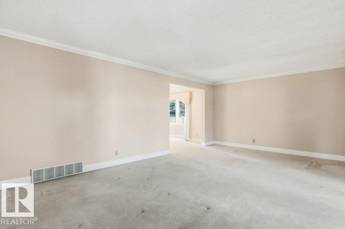 Unfurnished room with carpet flooring, crown molding, and a textured ceiling - 14335 47 Avenue, Edmonton, AB - Indoor Photo Showing Other Room