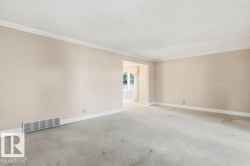 Unfurnished room with carpet flooring, crown molding, and a textured ceiling - 