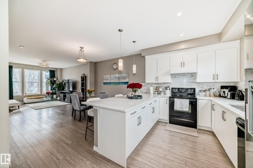 Kitchen featuring a breakfast bar area and quartz countertops - 8162 Chappelle Way, Edmonton, AB - Indoor Photo Showing Kitchen With Upgraded Kitchen