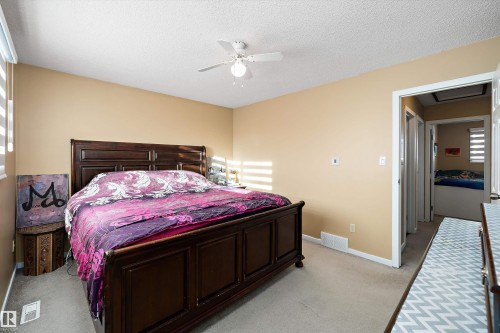 Bedroom featuring light carpet, a textured ceiling, and a ceiling fan - 9804 156 Avenue, Edmonton, AB - Indoor Photo Showing Bedroom