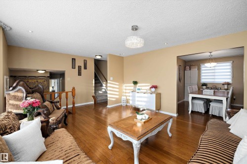 Living area with hardwood / wood-style flooring and a textured ceiling - 9804 156 Avenue, Edmonton, AB - Indoor Photo Showing Living Room