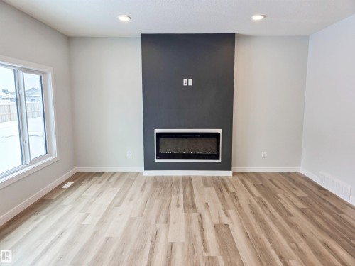 219 Ravine Drive, Devon, AB - Indoor Photo Showing Living Room With Fireplace