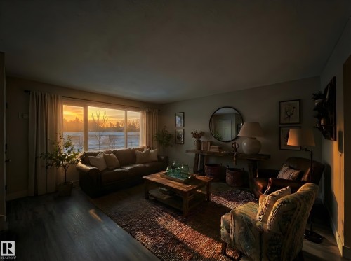 Living room featuring dark wood-style flooring and baseboards - 11357 22 Avenue, Edmonton, AB - Indoor Photo Showing Living Room
