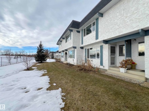 Yard covered in snow featuring a lawn - 11357 22 Avenue, Edmonton, AB - Outdoor
