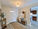 Entryway with light wood-type flooring and a textured ceiling - 11357 22 Avenue, Edmonton, AB  - Indoor 