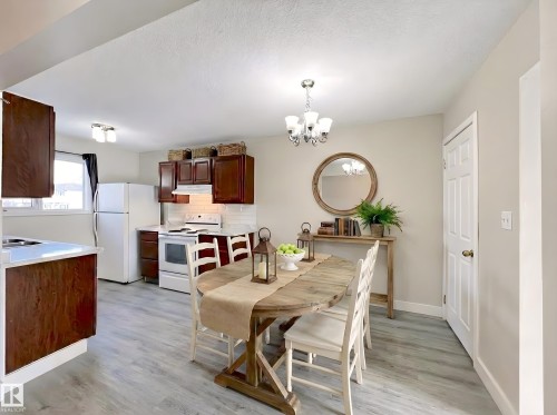Dining room featuring hanging lights and light wood finished floors - 11357 22 Avenue, Edmonton, AB - Indoor