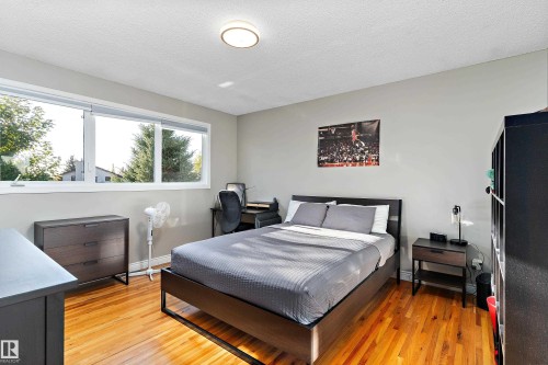 Bedroom featuring a textured ceiling and light wood-type flooring - 317 Grand Meadow Crescent, Edmonton, AB - Indoor Photo Showing Bedroom