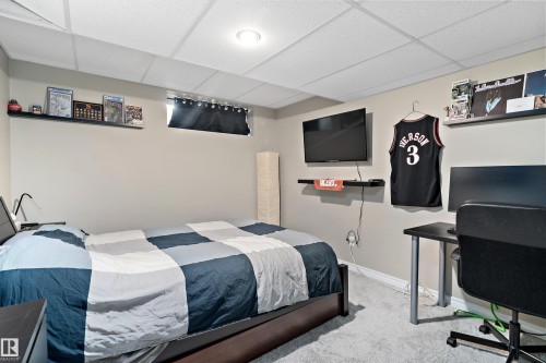 Bedroom with a paneled ceiling, carpet floors, and an office area - 317 Grand Meadow Crescent, Edmonton, AB - Indoor Photo Showing Bedroom
