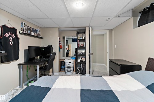 Bedroom featuring a drop ceiling and baseboards - 317 Grand Meadow Crescent, Edmonton, AB - Indoor