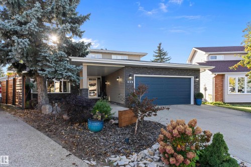 View of front of home with driveway, an attached garage, and covered porch - 317 Grand Meadow Crescent, Edmonton, AB - Outdoor