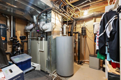Utility room featuring water heater and heating unit - 317 Grand Meadow Crescent, Edmonton, AB - Indoor Photo Showing Basement