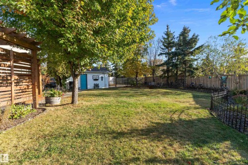 Fenced backyard featuring a pergola and an outdoor structure - 317 Grand Meadow Crescent, Edmonton, AB - Outdoor