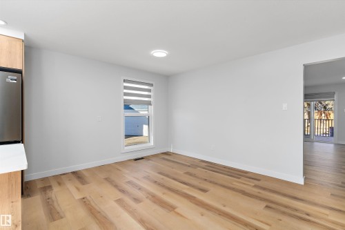 Spare room featuring light wood-style flooring and baseboards - 17116 81 Avenue, Edmonton, AB - Indoor Photo Showing Other Room