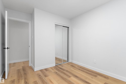 Unfurnished bedroom with a closet and light wood-style flooring - 17116 81 Avenue, Edmonton, AB - Indoor Photo Showing Other Room