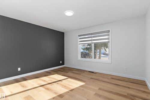 Unfurnished room with light wood-style flooring and baseboards - 17116 81 Avenue, Edmonton, AB - Indoor Photo Showing Other Room