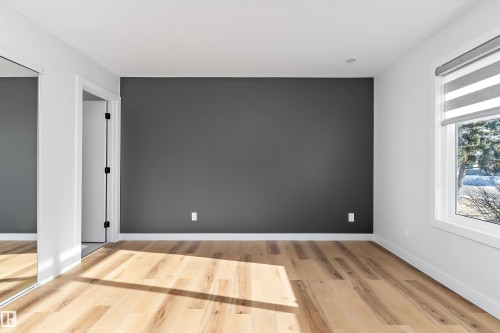 Unfurnished bedroom with light wood finished floors and a closet - 17116 81 Avenue, Edmonton, AB - Indoor Photo Showing Other Room