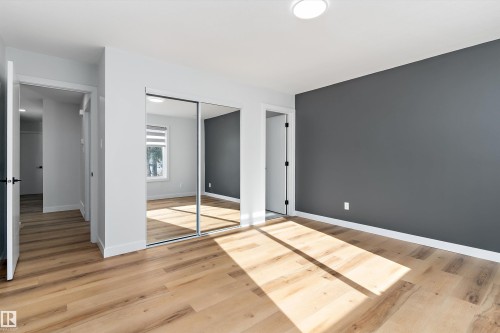 Unfurnished bedroom featuring light wood-style flooring and a closet - 17116 81 Avenue, Edmonton, AB - Indoor Photo Showing Other Room