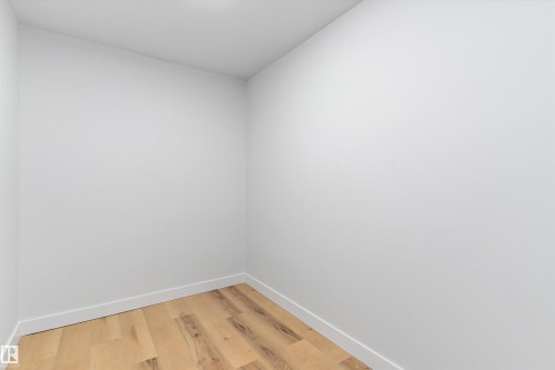 Empty room with baseboards and light wood-style flooring - 17116 81 Avenue, Edmonton, AB - Indoor Photo Showing Other Room