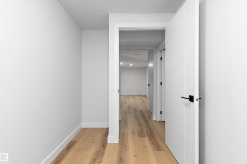 Hall with light wood-style floors and baseboards - 17116 81 Avenue, Edmonton, AB - Indoor Photo Showing Other Room