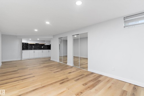 Finished below grade area featuring light wood-type flooring and recessed lighting - 17116 81 Avenue, Edmonton, AB - Indoor Photo Showing Other Room