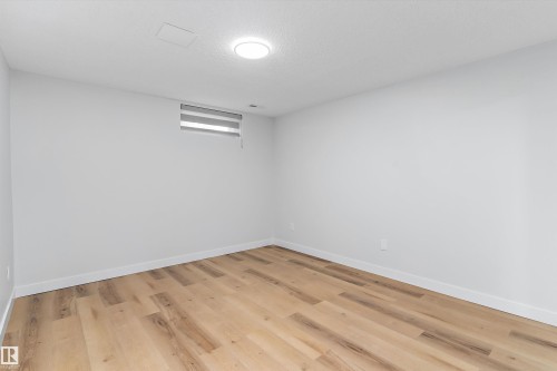 Spare room with light wood-style flooring and baseboards - 17116 81 Avenue, Edmonton, AB - Indoor Photo Showing Other Room
