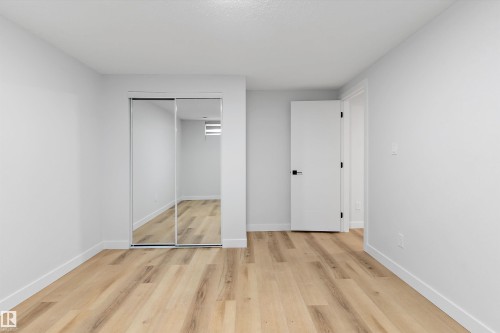 Unfurnished bedroom featuring light wood-type flooring and a closet - 17116 81 Avenue, Edmonton, AB - Indoor Photo Showing Other Room