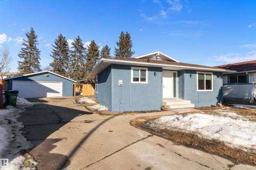 Single story home featuring an outdoor structure, stucco siding, and a garage - 17116 81 Avenue, Edmonton, AB - Outdoor