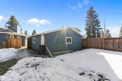 Snow covered property featuring a chimney and stucco siding - 17116 81 Avenue, Edmonton, AB - Outdoor