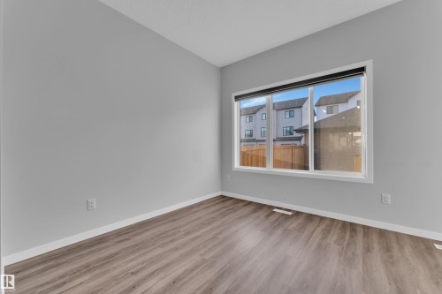 Spare room featuring light wood-style floors and baseboards - 1235 16 Avenue, Edmonton, AB - Indoor Photo Showing Other Room