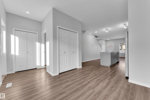 Unfurnished living room featuring light wood finished floors and recessed lighting - 1235 16 Avenue, Edmonton, AB - Indoor