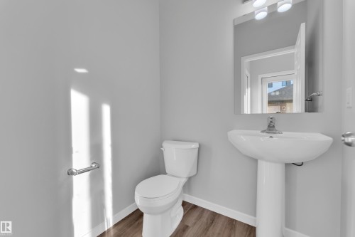 Half bath with toilet and wood finished floors - 1235 16 Avenue, Edmonton, AB - Indoor Photo Showing Bathroom