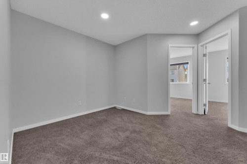 Empty room featuring dark colored carpet and recessed lighting - 1235 16 Avenue, Edmonton, AB - Indoor Photo Showing Other Room