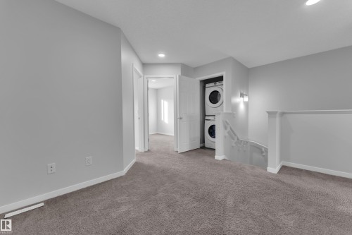 Unfurnished living room with stacked washer / dryer, carpet, and recessed lighting - 1235 16 Avenue, Edmonton, AB - Indoor Photo Showing Other Room