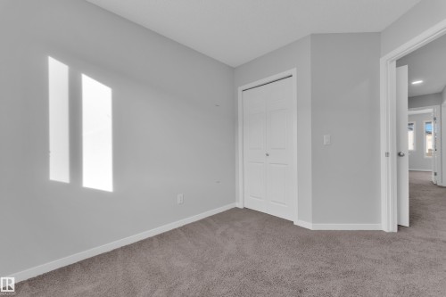 Unfurnished bedroom featuring carpet flooring and a closet - 1235 16 Avenue, Edmonton, AB - Indoor Photo Showing Other Room