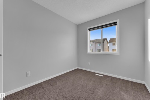 Carpeted spare room featuring baseboards and a textured ceiling - 1235 16 Avenue, Edmonton, AB - Indoor Photo Showing Other Room