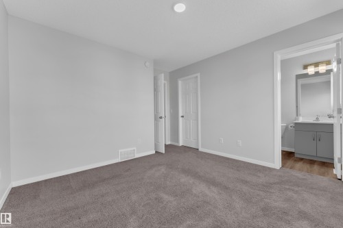 Unfurnished bedroom featuring carpet floors and ensuite bathroom - 1235 16 Avenue, Edmonton, AB - Indoor Photo Showing Other Room