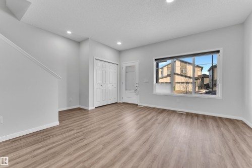 Foyer with light wood-type flooring, a textured ceiling, and recessed lighting - 1235 16 Avenue, Edmonton, AB - Indoor
