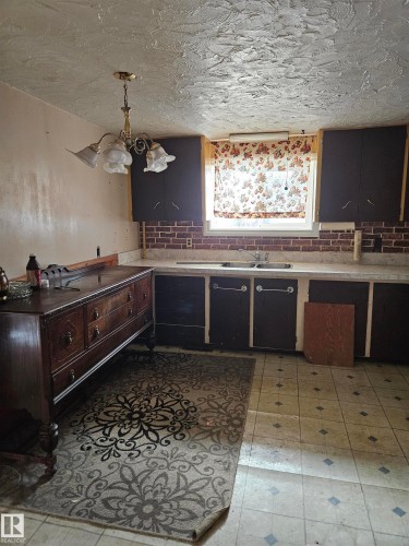 Kitchen featuring light countertops, decorative light fixtures, light floors, and a textured ceiling - 5314 57 Street, Cold Lake, AB - Indoor