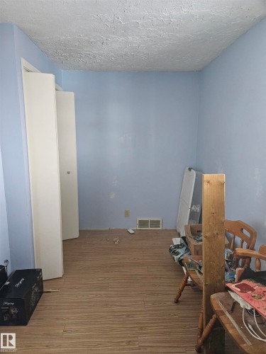 Misc room featuring hardwood / wood-style floors and a textured ceiling - 5314 57 Street, Cold Lake, AB - Indoor Photo Showing Other Room