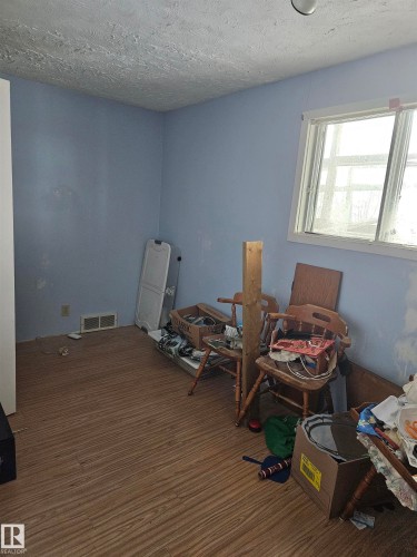 Miscellaneous room with a textured ceiling and wood finished floors - 5314 57 Street, Cold Lake, AB - Indoor