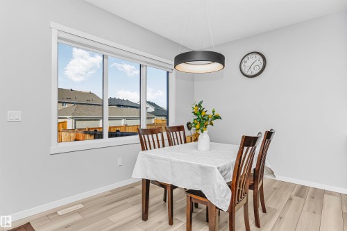 Dining area with light wood-type flooring and baseboards - 3108 158 Street, Edmonton, AB - Indoor Photo Showing Dining Room