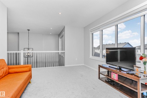 Living area with light colored carpet and hanging lights - 3108 158 Street, Edmonton, AB - Indoor