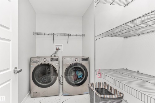 Laundry room with independent washer and dryer and baseboards - 3108 158 Street, Edmonton, AB - Indoor Photo Showing Laundry Room