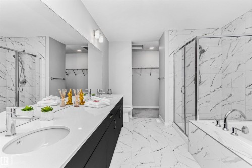 Bathroom featuring a walk in closet, a marble finish shower, and double vanity - 3108 158 Street, Edmonton, AB - Indoor Photo Showing Bathroom