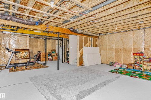 Unfinished below grade area with water heater - 3108 158 Street, Edmonton, AB - Indoor Photo Showing Basement