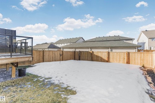 Snowy yard with a residential view, a fenced backyard, and a deck - 3108 158 Street, Edmonton, AB - Outdoor