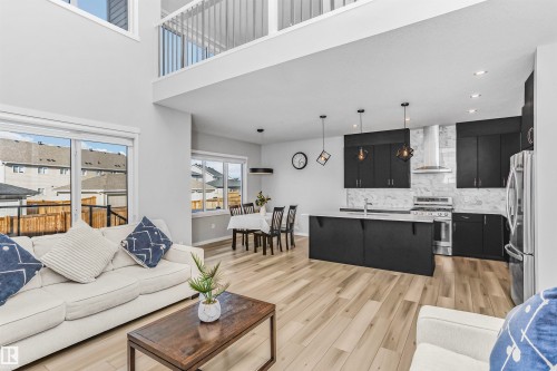 Living area with light wood finished floors, a high ceiling, and recessed lighting - 3108 158 Street, Edmonton, AB - Indoor