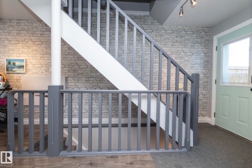 Stairway featuring brick wall - 4371 46 Street, Stony Plain, AB - Indoor Photo Showing Other Room