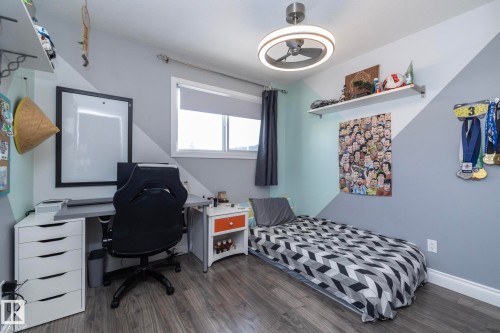 Bedroom featuring an office area and dark wood-style flooring - 4371 46 Street, Stony Plain, AB - Indoor Photo Showing Bedroom